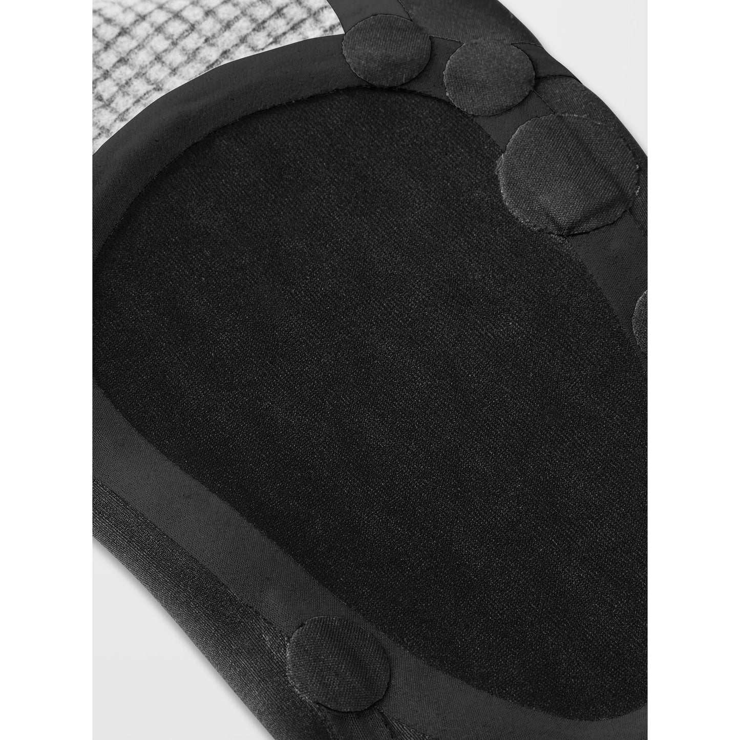 
                  
                    Close-up of a black cushion with textured edges on a white background
                  
                