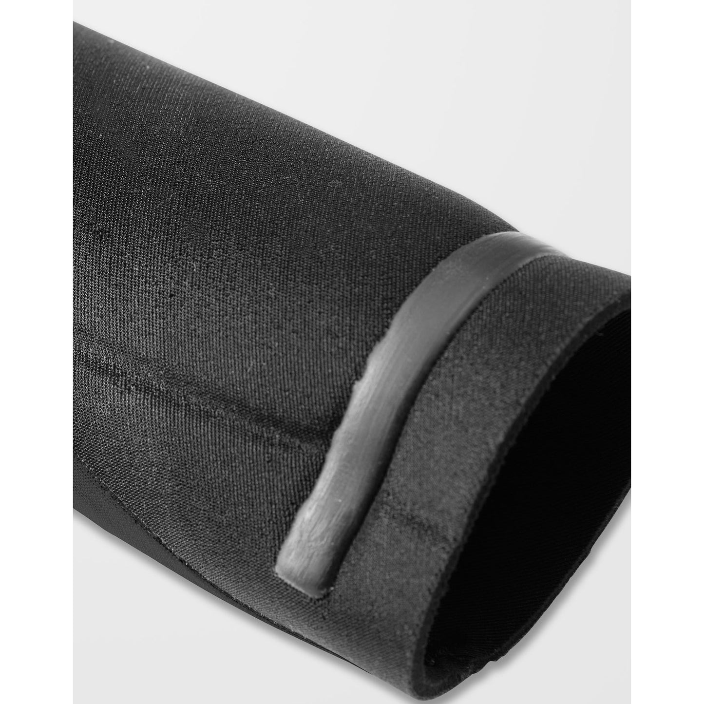 
                  
                    Black cylindrical object with a ribbed texture on a white background
                  
                