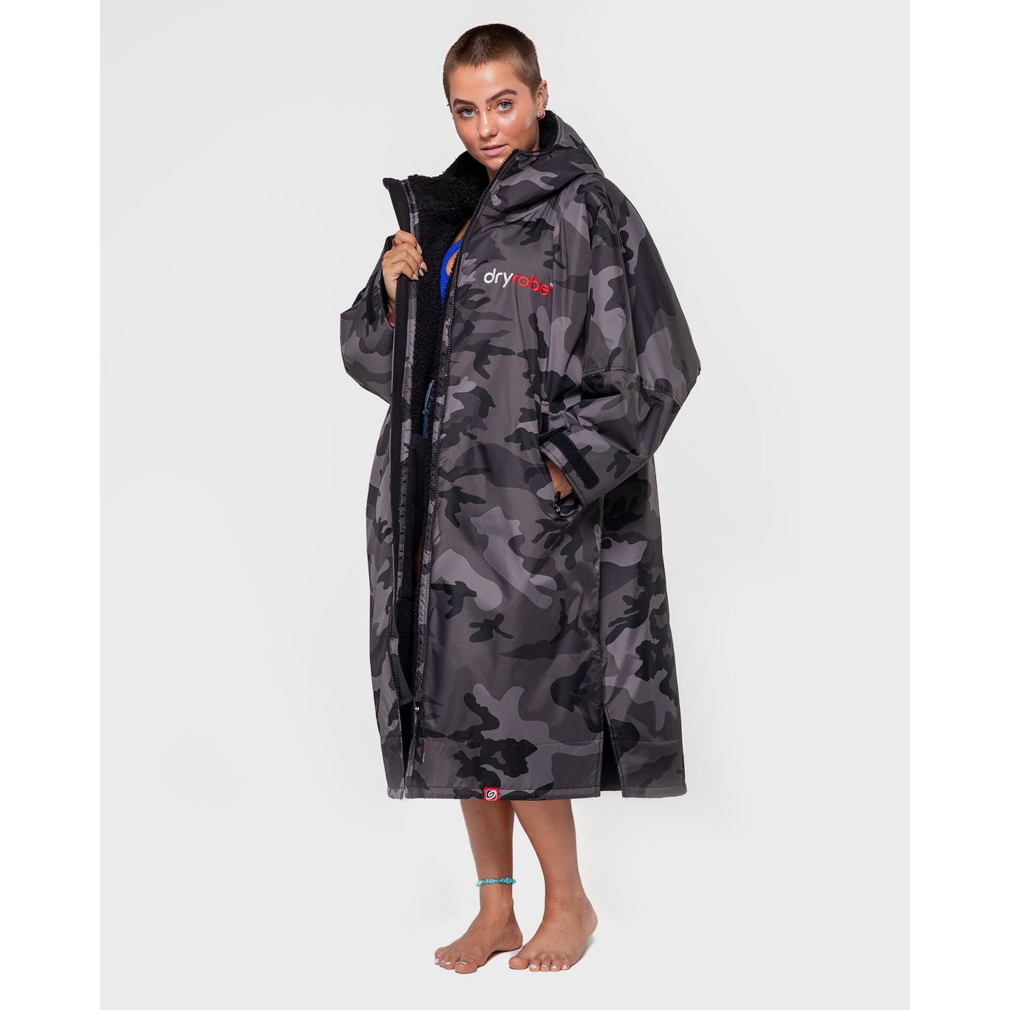 Person wearing a camouflage dryrobe on a white background