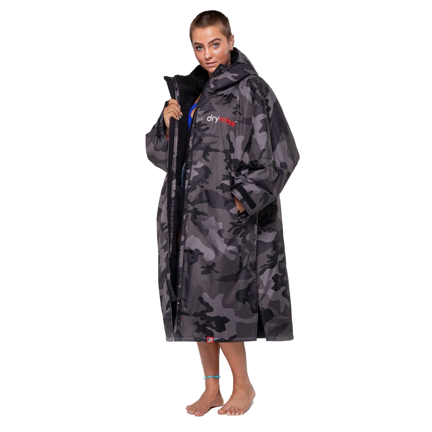 Person wearing a gray camouflage dryrobe on a white background